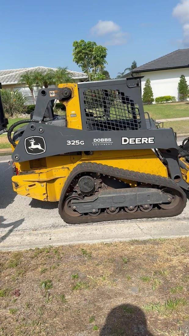 Compact loader used for land clearing and debris work